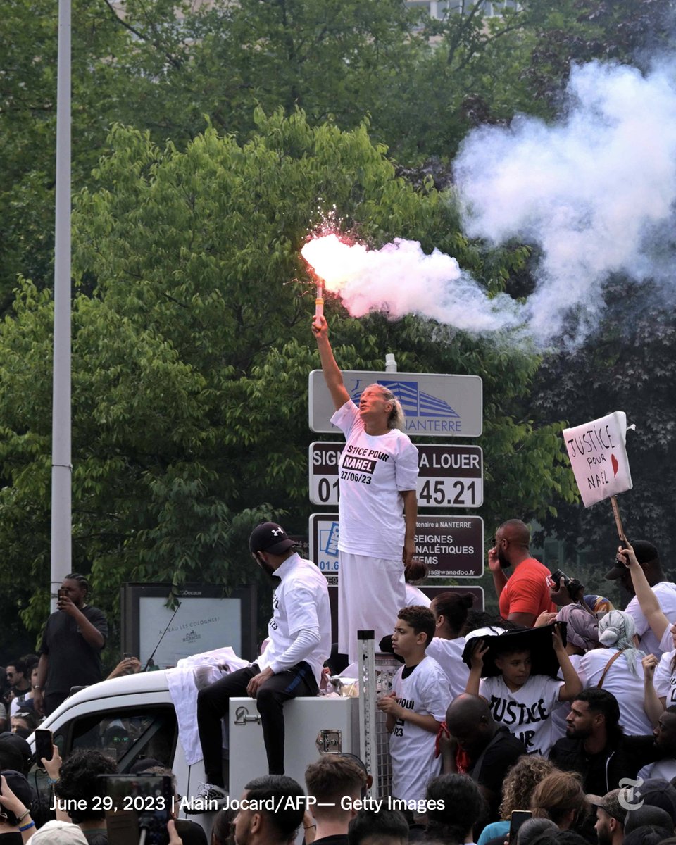 A vigil march for Nahel M., the 17-year-old shot by the police in France this week, arrived at the court building in Nanterre, the Paris suburb where the shooting took place. Nahel’s mother held up a firecracker in a sea of people chanting her son’s name. nyti.ms/3JBJOle