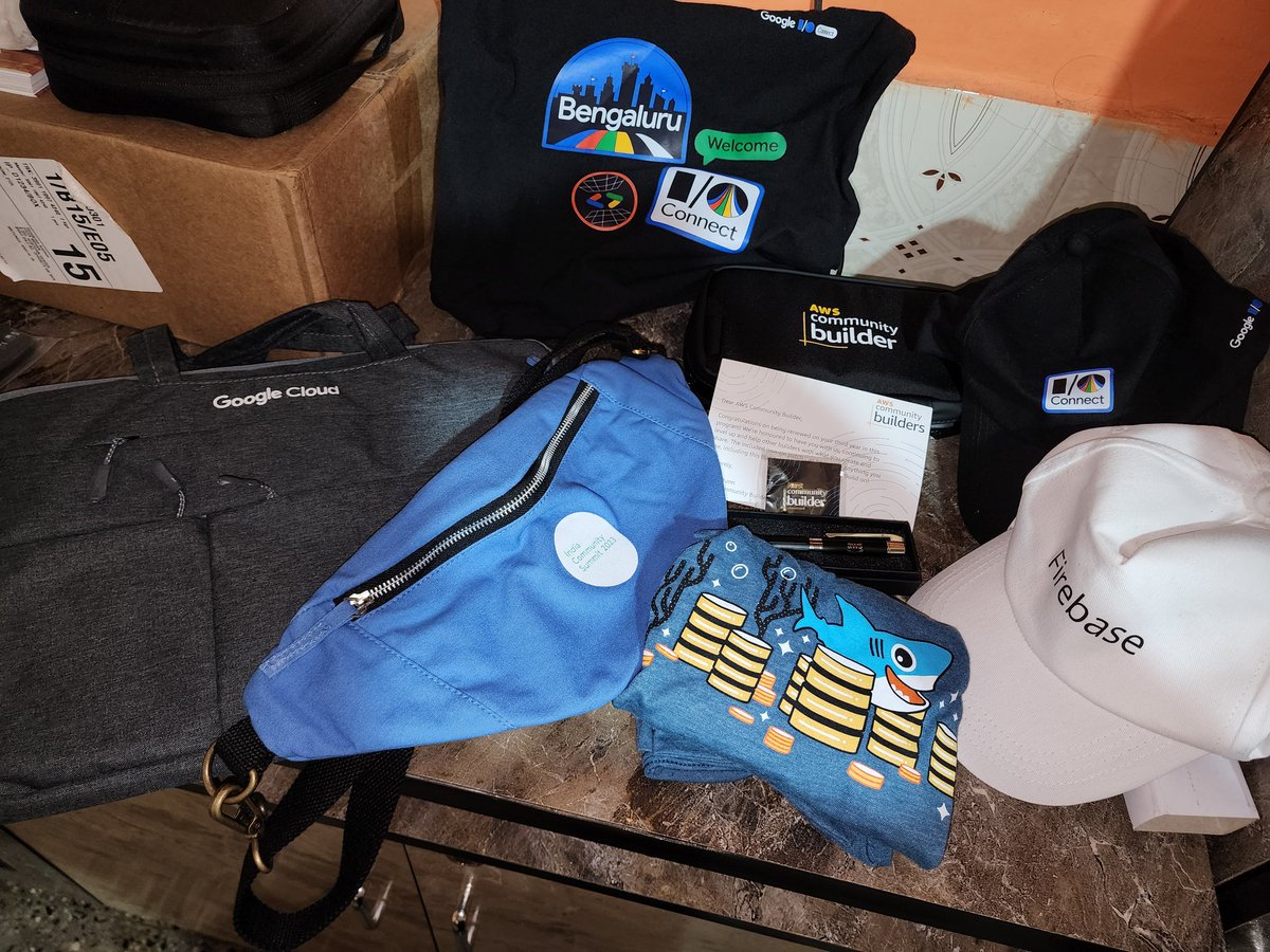 ghumare64's tweet image. Reached home 🏡 

Opened the bag of swags from #GoogleIOConnect and #ics2023 !!

Found @awscloud swags at home 😇🎁

Excited to announce third year as a AWS Community Builder ☁️🥳

PS: Guess the extra swag with shark!