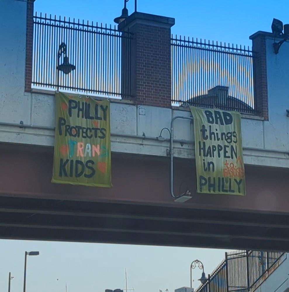 GrimKim's tweet photo. Banner drop over I-95 this morning. The M4L hate summit begins tonight with a opening reception at @AmRevMuseum. Show up at 5pm to, uh, “welcome” them. 

“Philly Protects Trans Kids”

“Bad Things Happen to Fascists in Philadelphia” https://t.co/r03WfLGog7