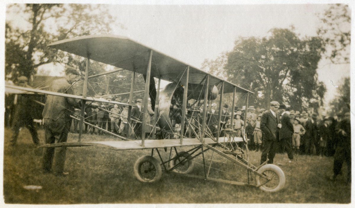 For this #ACAHashtagParty we are flying high with this picture from 1914. A Californian pilot Lincoln Beachey raced Barney Oldfield around the track at the exhibition grounds in Belleville Ontario, with Beachey’s biplane just above the race car. <a href="/archivistsdotca/">ACA</a>