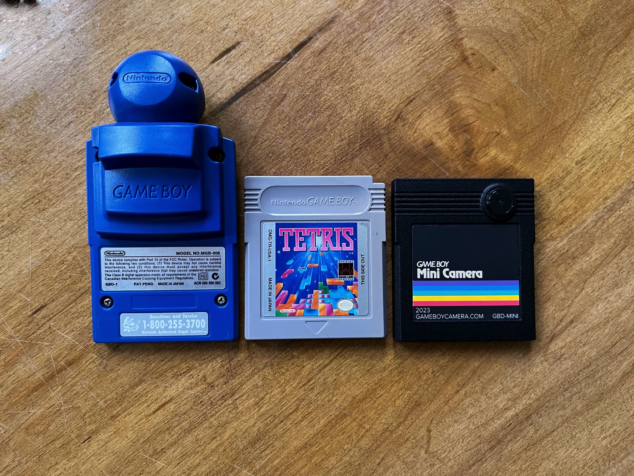 Comparing an original blue Game Boy Camera and a Tetris cart with the Mini Camera