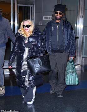NewMadonna1's tweet image. Madonna (looking hotttt) and boyfriend Akeem Morris at the JFK airport in New York City today