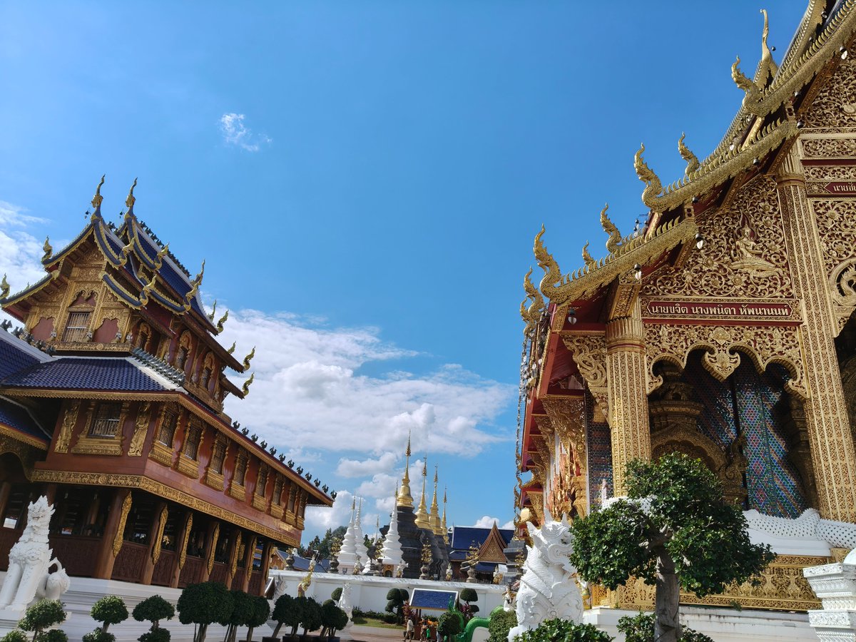 budgetcatcher's tweet photo. Wat Den Sali Sri Muang Kaen (Wat Ban Den) - A Lanna Masterpiece Near Chiang Mai

If you’re exploring northern Thailand and looking for a temple that truly stands out, Wat Den Sali Sri Muang Kaen, better known as Wat Ban Den, should be high on your list. Located about 45 minutes north of Chiang Mai, this impressive temple complex is one of the most beautiful and least crowded cultural gems in the region.

A Temple That Feels Like an Open-Air Museum

Wat Ban Den is not just one temple building - it’s a vast complex made up of multiple halls, stupas, and shrines, each designed in classic Lanna style. Expect elegant roofs, golden details, colorful mosaics, and perfectly symmetrical architecture that looks almost unreal in the bright northern Thai sunlight.

Every corner of the temple feels carefully crafted. Whether you’re walking up the grand stairways, admiring the guardian statues, or exploring the different prayer halls, the entire place feels more like a spiritual art park than a single temple.

A Perfect Stop for a Half-Day Trip

Wat Ban Den is easy to combine with a countryside ride or road trip north of Chiang Mai. The journey itself is scenic, passing rice fields, small villages, and mountain landscapes.

📍 Location: Mae Taeng District, about 45 km north of Chiang Mai
⏱️ Time needed: 1–2 hours is perfect
📸 Best for: Architecture lovers, photographers, peaceful explorers