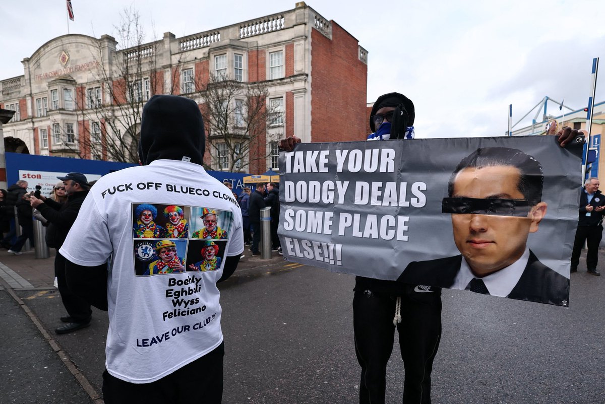 JacobsBen's tweet photo. A few hundred Chelsea fans currently protesting against BlueCo ahead of the game against Brentford. Some chanting Enzo Maresca’s name and others wearing Roman Abramovich shirts. https://t.co/iQ6GmRXSgM