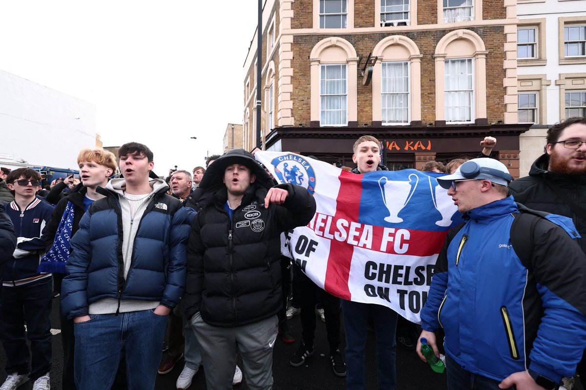 JacobsBen's tweet photo. A few hundred Chelsea fans currently protesting against BlueCo ahead of the game against Brentford. Some chanting Enzo Maresca’s name and others wearing Roman Abramovich shirts. https://t.co/iQ6GmRXSgM