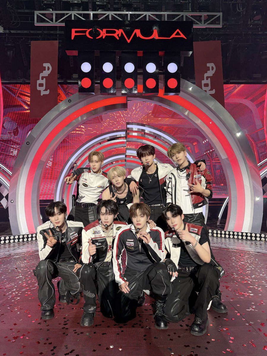 Sanghyeqn's tweet image. The first frame burns hot and precise, a 𝗙𝗼𝗿𝗺𝘂𝗹𝗮-red intensity charged with velocity and pressure. Every stance feels sharpened, every gaze tuned to performance mode. This is power measured in seconds and spotlights, an aura that races forward loud in confidence.