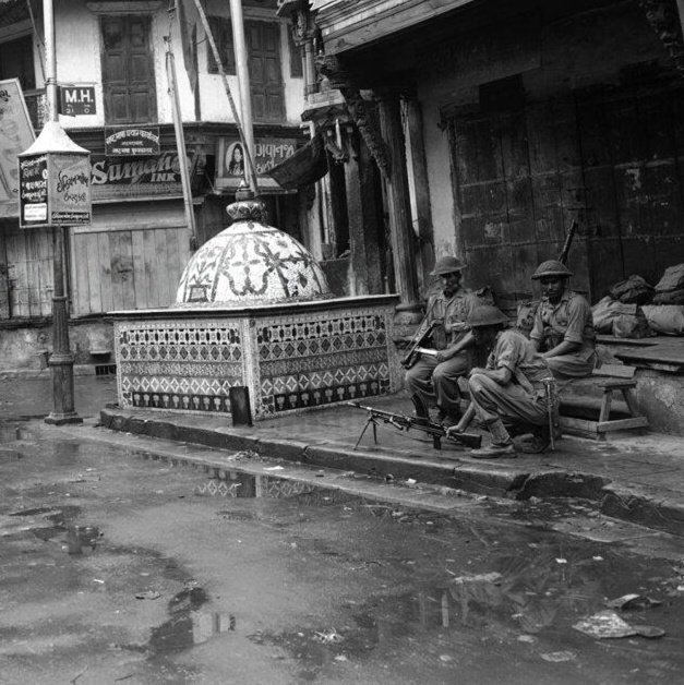 Soldiers of Rajputana rifles stand guard with a machine gun beside a Hindu Mandir during a riot

Ahmedabad, 1946