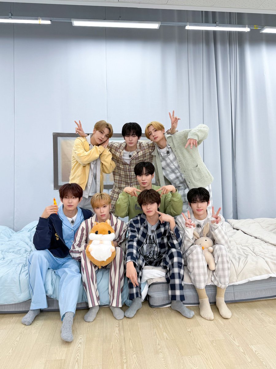 Sanghyeqn's tweet image. Soft fabrics, sleepy smiles, and laughter stitched between plaid and pastel tones—this is what comfort looks like when shared. Wrapped in pajamas and unguarded joy, the room feels warmer, lighter, as if time itself decided to slow down just to watch us enjoy the moment.