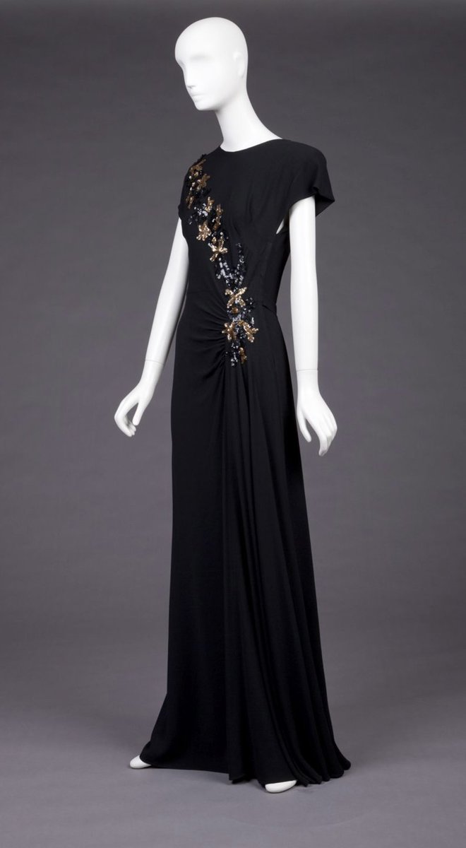 kateStrasdin's tweet image. Asymmetry beautifully executed here, taking black rayon crepe and draping it across the body at an angle, along with a sweep of metallic sequins. Mid #1940s evening wear on point #goldsteinmuseum #fashionhistory