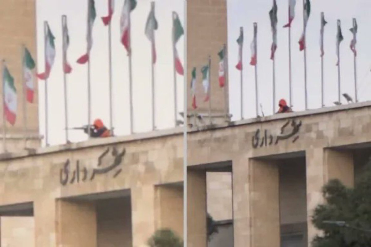 YourAnonOne's tweet image. BREAKING: Photos obtained by Iran International appear to show a sniper on the roof of Isfahan’s municipality building, aiming at protesters