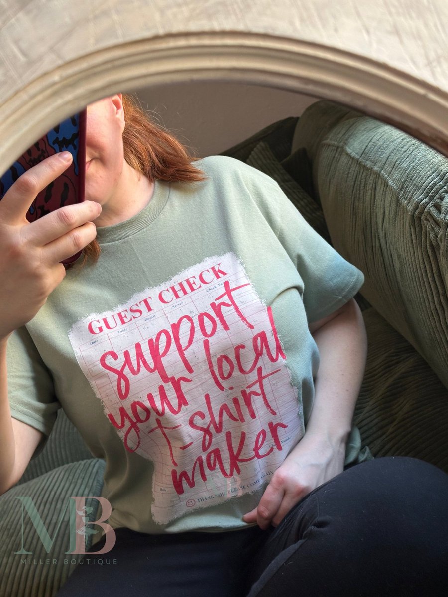 Face covered, hustle on. 📸 ✨ 

I might be hiding behind the phone, but I'm the one hand-pressing every order at Miller Boutique. Every piece is made to order by my own two hands.

When you support your local T-shirt maker, you're supporting a dream. 🕊️ 

Millerboutique.com