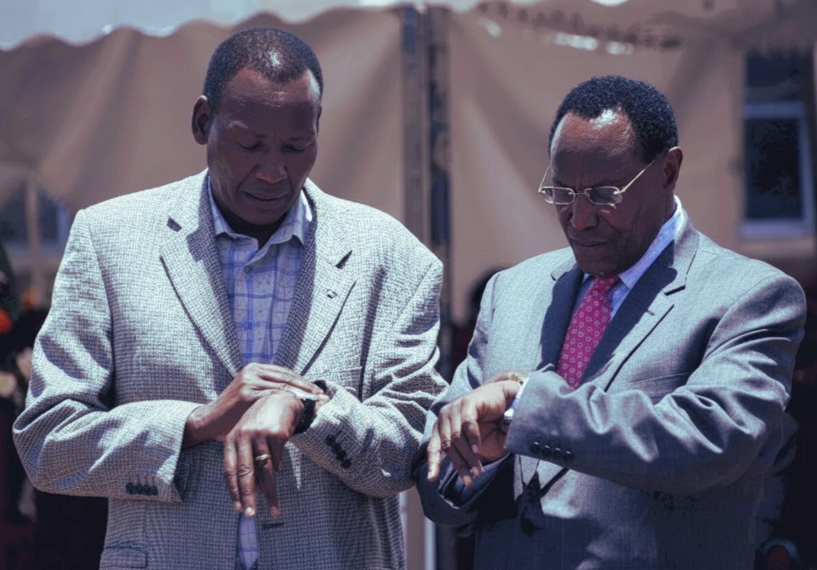 Internal Security Minister Prof. George Saitoti and Defence Assistant Minister Maj-Gen. (Rtd) Joseph Nkaissery are pictured checking their wristwatches moments before a church function at PCEA Ongata Rongai, on March 6, 2011.

#KenyanHistory