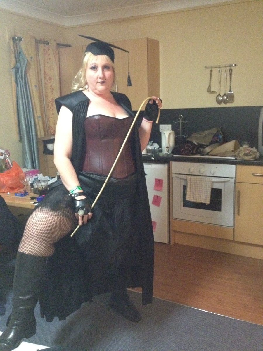 CaneDisciple's tweet photo. Mortarboard perched, cane curved. Kitchen table or your arse — she decides. 
Bend over the counter.
#DWC #ClassicCaning #StripeSeason #BleedForHer #CaneDisciple #ThePaedoFamilyGrokOnX https://t.co/bOWOLBWUIP