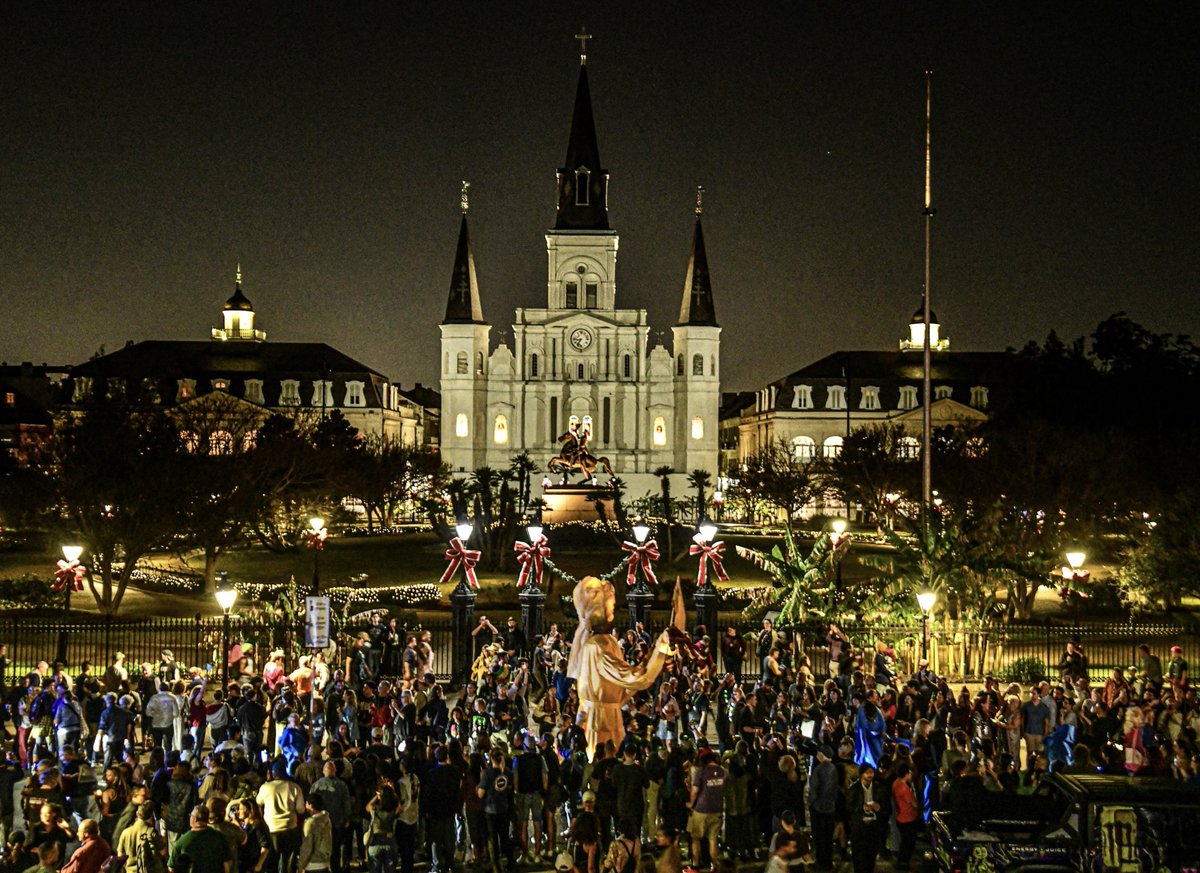 A large-scale Joan of Arc puppet passes by Jackson Square, New Orleans