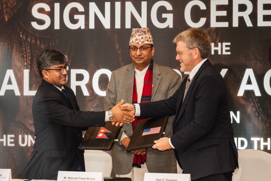 Ambassador Thompson shaking hands after the signing ceremony.