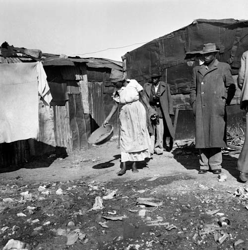 HistorySAZAR's tweet image. Residents standing outside their shacks, c 1950s - 60s. Image Source: Jansje Wissema Collection/UCT Photography Collection