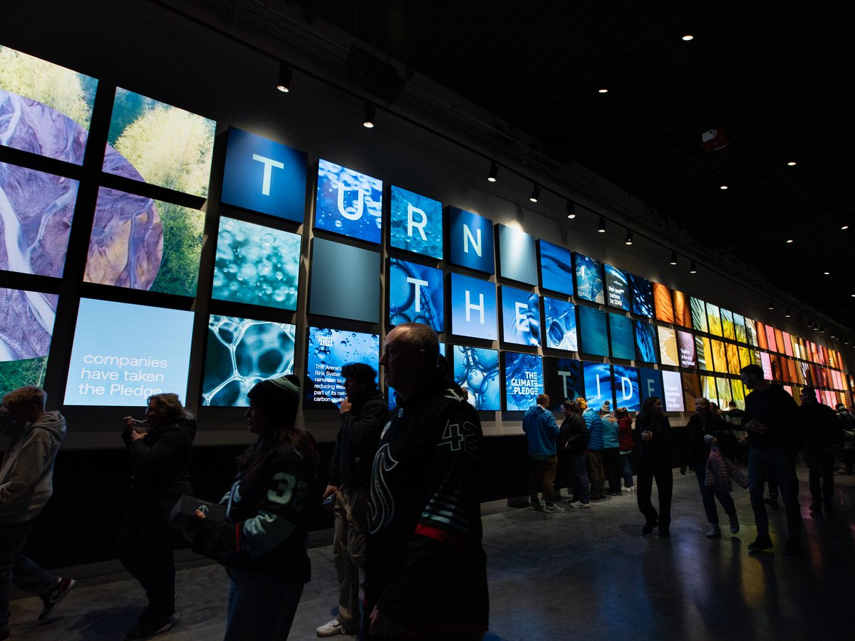 climatepledge's tweet image. The refreshed East and West walls at @ClimateArena use macro photography, motion, and layered visuals to spark curiosity and make climate action feel more accessible for the millions who pass through each year.