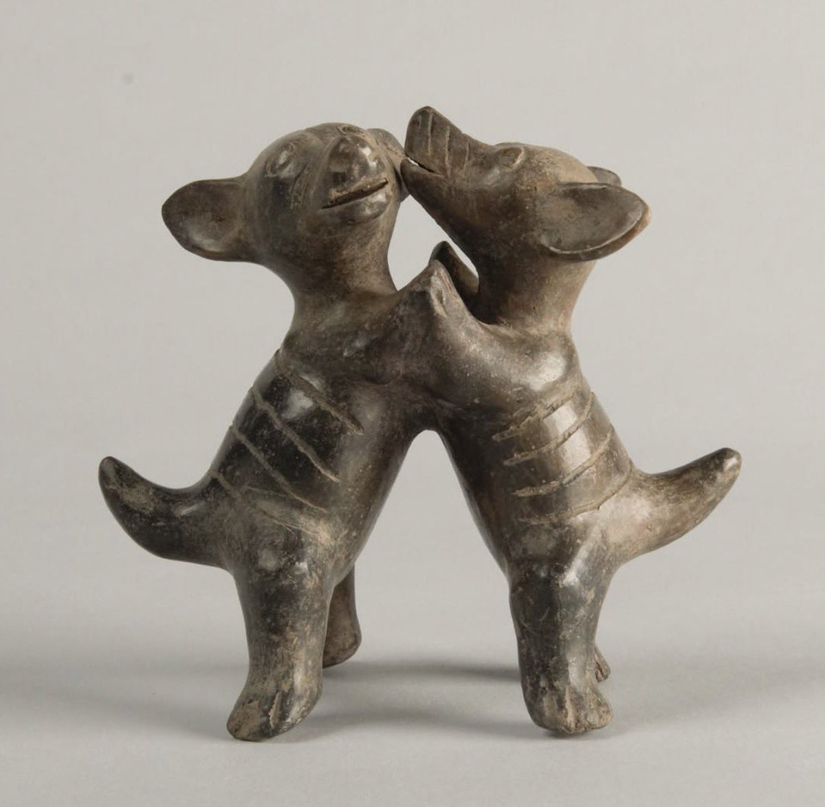 sending him the ceramic sculpture of dancing chihuahuas from mexico 200 BC-AD 200 with caption “us”