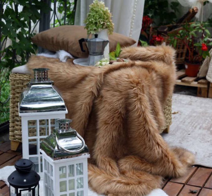 haven51737's tweet photo. It’s the details that set the mood. A rattan ottoman with a soft fur blanket, paired with glowing candle lanterns, adds instant warmth and character to any outdoor deck. https://t.co/vOO7UgHWYU