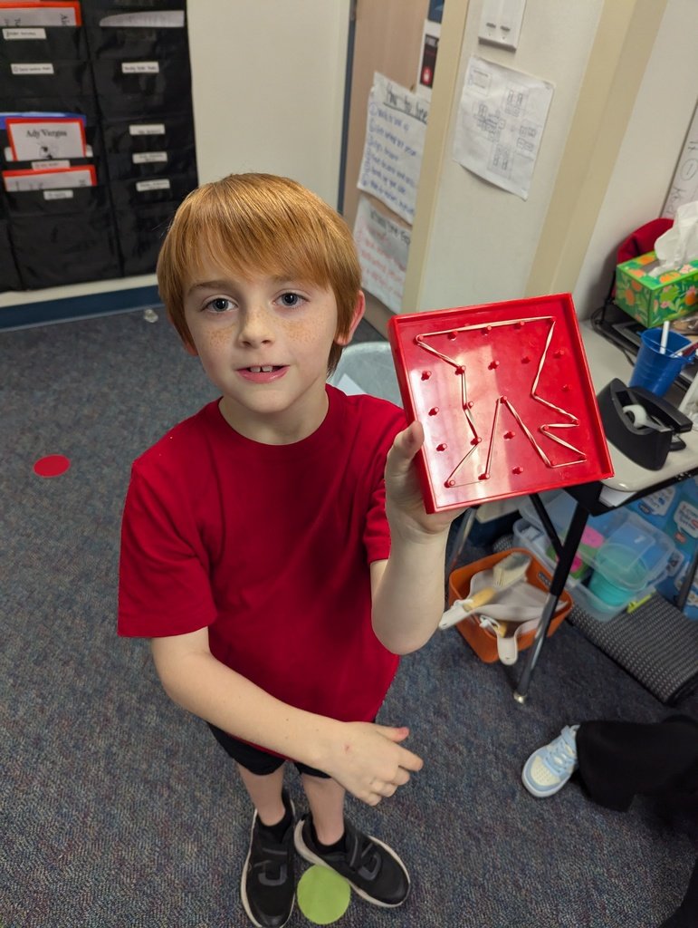 2nd grade is exploring polygons with geoboards
