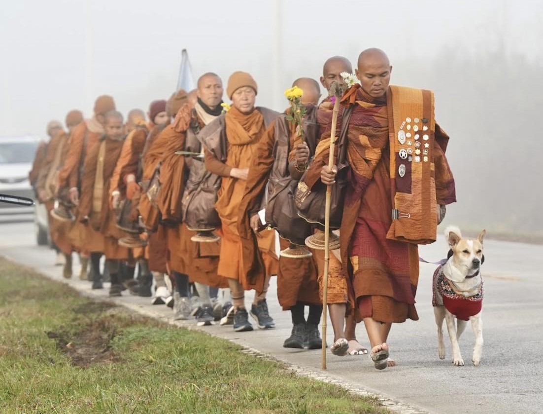 ThaiEnquirer's tweet photo. Buddhist monks reach South Carolina on 77th day of 2,300-mile ‘Walk for Peace’ across US

A group of Buddhist monks undertaking a long-distance walking pilgrimage across the United States has reached South Carolina, continuing their journey from Texas to Washington, D.C., to promote peace, compassion and non-violence.

Now on day 77 of the 120-day trek, the monks are scheduled to walk into the centre of Columbia on Saturday, January 10, and hold a Peace Gathering at the South Carolina State House. Organisers said the group will assemble in the early afternoon at a riverside park in West Columbia before walking together to the state capitol, inviting members of the public to join.

The group of about two dozen monks began the “Walk for Peace” in Fort Worth, Texas, on Oct 26 and is covering an estimated 2,300 miles on foot to the US capital. The journey has drawn widespread attention, with hundreds of supporters greeting the monks along the route and more than 400,000 followers tracking their progress on social media.

The monks regularly share updates, reflections and poetry online and are accompanied by a dog named Aloka, whose name comes from a Sanskrit word meaning “enlightenment,” and which has become a symbol of the walk.

The pilgrimage has faced challenges, including physical strain and safety risks. In December, a truck struck the group’s escort vehicle in Texas, pushing it into two monks and leaving one seriously injured. Organisers said the injured monk is expected to recover following surgery.

Despite the hardships and occasional differing views encountered along the way, organisers have stressed that the walk is not about politics or religious conversion, but about encouraging unity, compassion and mutual understanding, reflecting Buddhism’s long tradition of peace activism.

#Thailand #US #Buddhism #WalkForPeace