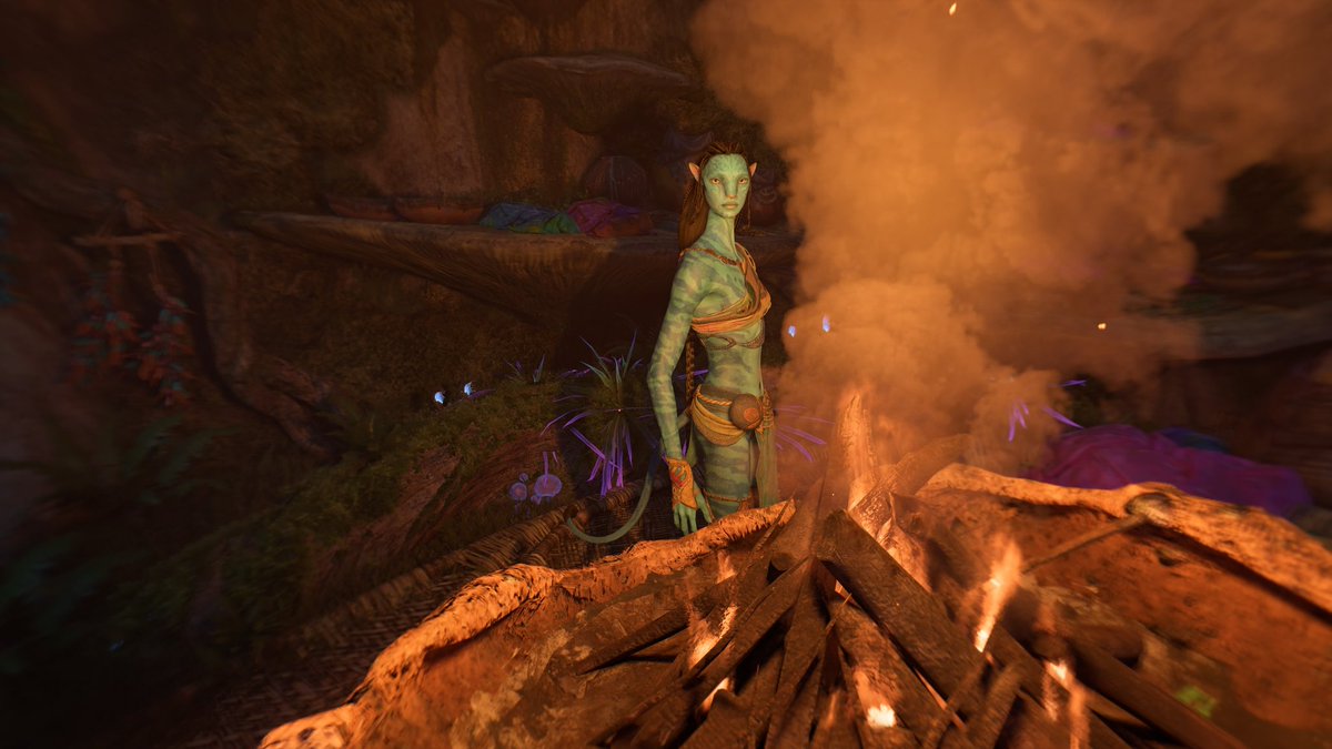 She looks at the reader from across the fire.