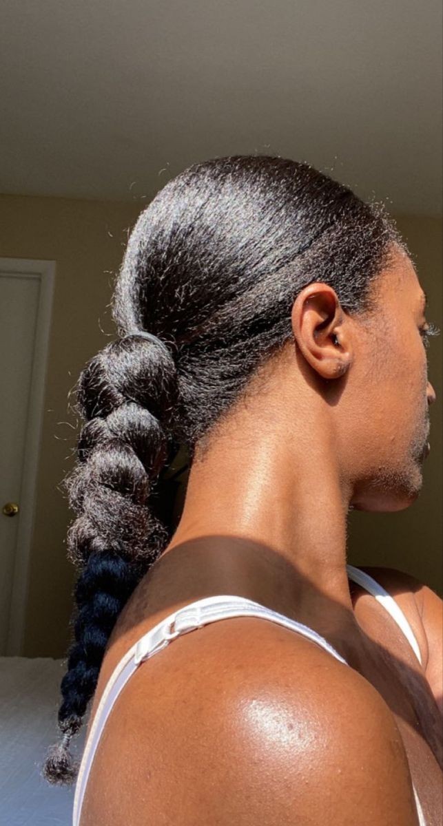 Wearing it natural doesn't necessarily mean it would be out like in the video...it could be styles like this