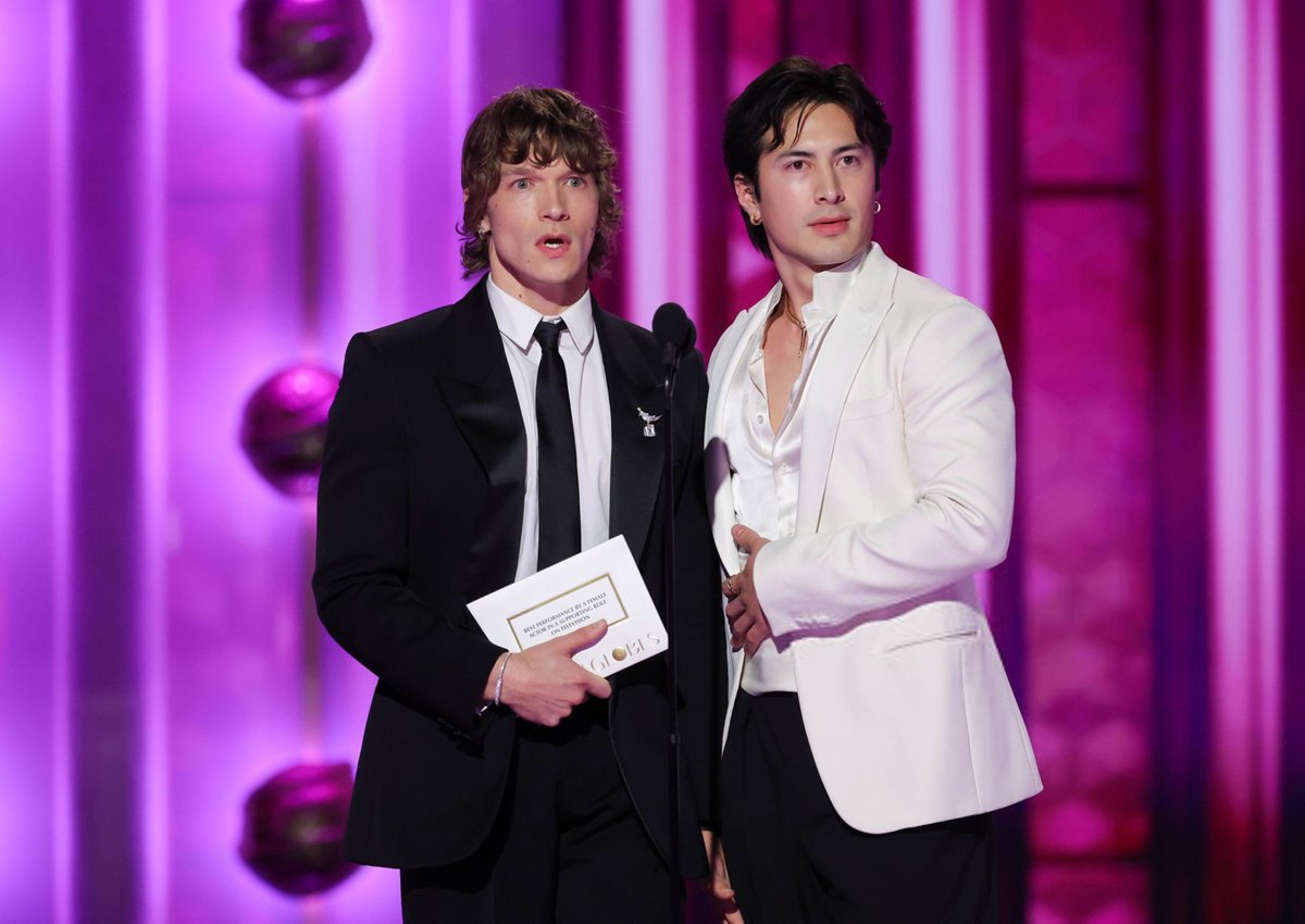 connorstupdates's tweet photo. VANITY FAIR:  Connor Storrie and Hudson Williams Put Their Backs Into It at the Golden Globes 2026

"It doesn’t matter that they weren’t eligible for awards. The Heated Rivalry stars were the big winners of the night anyway.
Williams and Storrie got prime seating placement at the Globes, sitting at a table with Paul Mescal, Charli xcx, Keegan-Michael Key, and Justin Hartley—and right next to the table where Leonardo DiCaprio was seated. They did red carpet interviews: Storrie wearing a black Saint Laurent suit with a thin black tie, draped in Tiffany and Co. jewelry, and Williams in a black and white Armani tuxedo — cummerbund included — Louboutin shoes, and Bulgari jewelry. [...] The two even got to enjoy that very specific awards show rite of passage: a joke written into the host’s banter."

🔗 Read the full article here: https://t.co/cX1Vievkwr