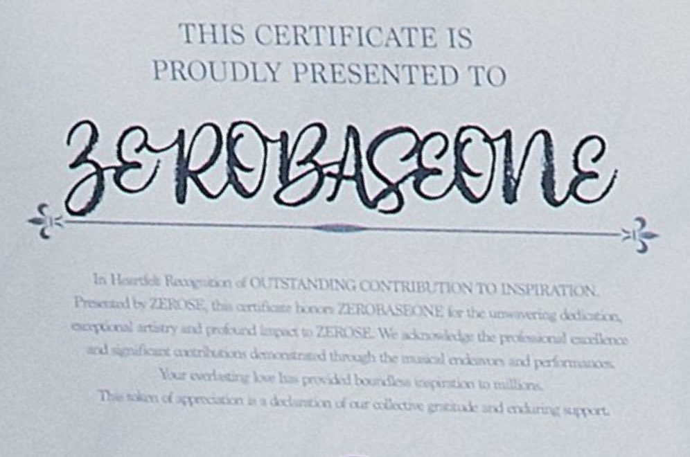 "In Heartfelt Recognition of OUTSTANDING CONTRIBUTION TO INSPIRATION.
Presented by ZEROSE, this certificate honors ZEROBASEONE for the unwavering dedication, exceptional artistry and profound impact to ZEROSE. We acknowledge the professional excellence and significant