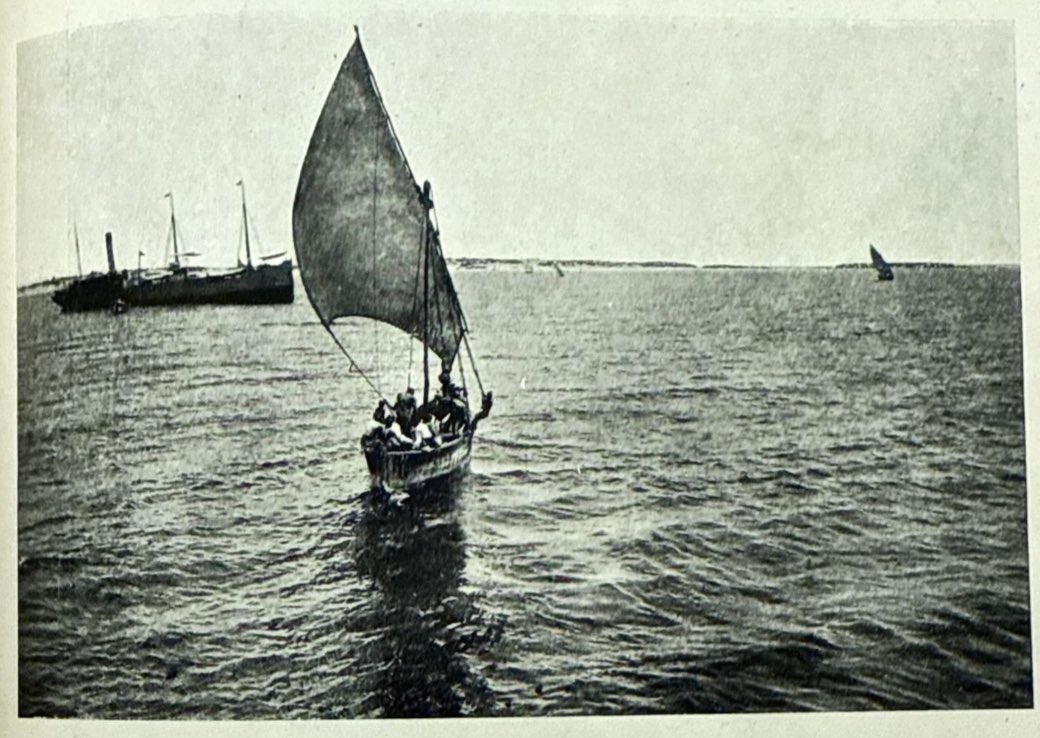 archivesSomalia's tweet photo. Baraawe, 1913 — somali fishermen on a boat gliding across the water, with an Italian warship looming in the background. https://t.co/akFqnv7nzP