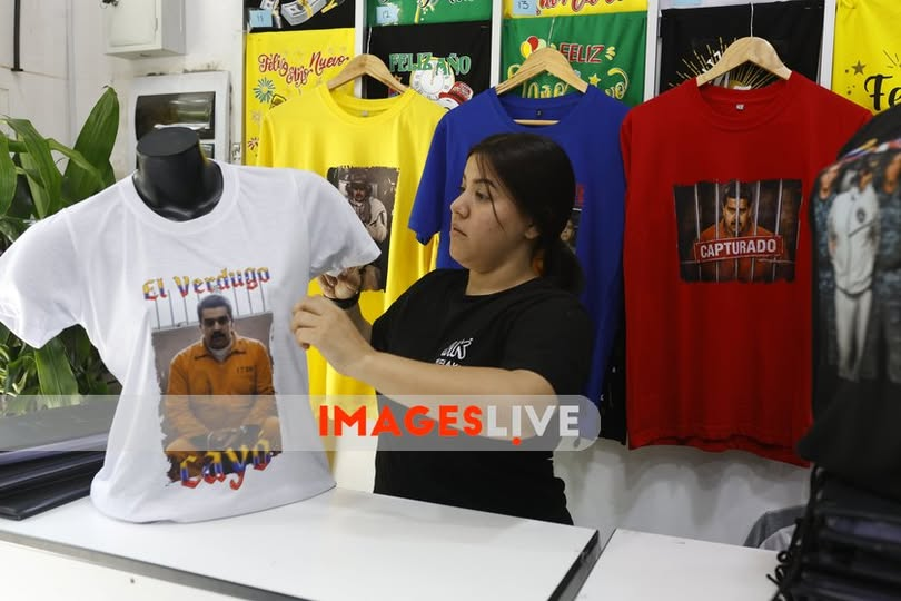 imageslive's tweet photo. Lima, Peru: Yanelis Torres, a Venezuelan graphic designer, places an order for T-shirts printed with digitally manipulated images depicting Venezuelan President Nicolás Maduro as captured by the United States government, at the Gamarra textile emporium in Lima. https://t.co/9GvjsahClE