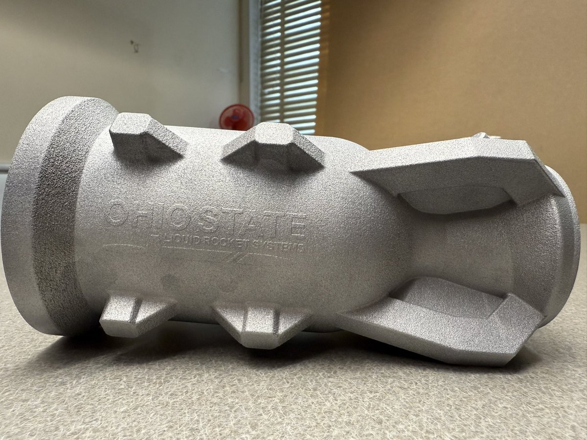 Space_RT_2399's tweet photo. I'm thrilled to present Ohio State Liquid Rocket Systems' newest engine, Valkyrie.

Made on campus from 3d printed aluminum, and with a design thrust of 2.22 kN and an ISP of 200s, this engine will propel our next generation rocket to an apogee of 15,000ft this coming May. https://t.co/9MoQbtqBkq