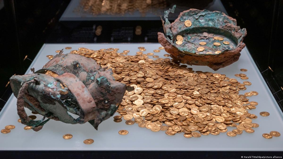 DetectingDigsUK's tweet photo. Largest Roman Gold Treasure Ever Found
The Trier Gold Hoard is one of the most spectacular archaeological discoveries of modern times—the largest preserved Roman gold hoard ever unearthed. Found in Trier, Germany (ancient Augusta Treverorum, a major Roman city), this collection of 2,516 gold coins weighs 18.5 kilograms and provides an extraordinary glimpse into the wealth, economy, and politics of the Roman Empire. Discovered by chance in 1993 during construction, it captured global attention and revealed a hidden chapter of history buried for nearly 1,800 years.
The Dramatic Discovery
On September 9, 1993, construction workers in Trier accidentally unearthed the hoard while digging for a new underground parking garage. An excavator tore open an ancient bronze cauldron, spilling gold coins across the site. Some coins and fragments were loaded onto trucks and taken to a nearby dump before anyone realized the significance.
Workers soon spotted the gleaming coins, and word spread quickly, drawing amateur treasure hunters.
An amateur archaeologist named Erich Eixner acted responsibly: using a metal detector at night, he located the main remnant of the cauldron, which still contained about 560 coins, plus a lump of roughly 1,500 more.
He reported the find to authorities.
The site had been cleared by archaeologists beforehand, so officials couldn’t claim the finders were looters.
Eixner received a modest reward of about 20,000 Deutsche Marks (around €10,000).
The incident highlighted the challenges of urban archaeology in a city as old as Trier, where Roman layers lie just below the surface.
Archaeologists from the Rheinisches Landesmuseum Trier took over, carefully recovering and cataloging the coins. The damaged bronze cauldron was reassembled as much as possible. The recovered total is 2,516 coins (some sources note 2,518 due to minor counting differences), though the original hoard may have held up to 2,650.
Many coins were in exceptional condition, protected from the elements for centuries.
The recovery process was complicated by treasure hunters at the dump site, but most of the hoard was secured for study and display.
The hoard consists of Roman aurei—gold coins that were the empire’s premier currency. Each weighs 5.8 to 7.6 grams, totaling 18.5 kilograms.
They feature portraits of over 40 emperors and family members, spanning more than a century of Roman history.
The coins display intricate designs: imperial busts on one side and symbolic scenes (victories, gods, or commemorative images) on the other. The collection includes rare double aurei (biniones) minted for special occasions or as gifts to soldiers and officials.
The coins are nearly pure gold (around 98%), and their selection suggests a deliberate, official treasury rather than a random personal stash. In ancient terms, the hoard was worth the annual pay of 130–200 legionaries.
Dating and Historical Context
The earliest coins date to 63 AD (Nero’s reign), while most (99%) were minted before 167 AD, under emperors like Trajan, Hadrian, and Marcus Aurelius. Only six coins are from 193–196 AD (early Septimius Severus), with the latest from 196 AD.
Trier was a prosperous provincial capital founded around 16 BC, with grand Roman monuments. By the late 2nd century, the empire faced plagues, civil wars, and invasions. The hoard’s timeline reflects a period of stability followed by turmoil.
Experts believe the hoard was first hidden around 167 AD, likely during the Antonine Plague—a pandemic that killed millions and caused widespread chaos.
The final burial occurred during the civil war of 196–197 AD.
Septimius Severus, after seizing power, faced rebellion from Clodius Albinus, governor of Britain. Albinus besieged Trier, a key Severus stronghold.
In the chaos, a high-ranking official buried the hoard in a cellar for safekeeping.
The custodian likely died before retrieving it, leaving the treasure hidden until 1993.