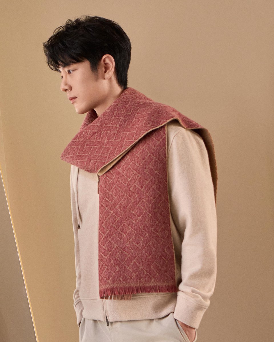 Global Brand Ambassador Xiao Zhan wearing the Tod's Limited Edition inspired by the Year of the Horse. Footwear, bags, ready-to-wear pieces, and small charms are enhanced by refined details and contrasting stitching, with red guiding the colour palette, symbolising good fortune