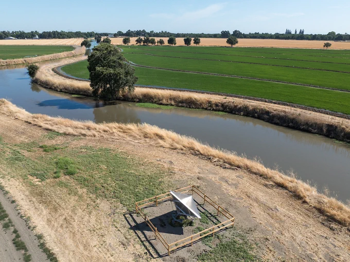 A drone view of newly installed equipment from the California Department of Water Resources' Sustainable Groundwater Management Office to enhance the monitoring and understanding of land subsidence in California. The newly installed GPS station and remote sensing calibration equipment are firmly anchored into the ground to ensure precise positioning and detect vertical movement of the Earth’s surface. Photo taken July 2, 2025.