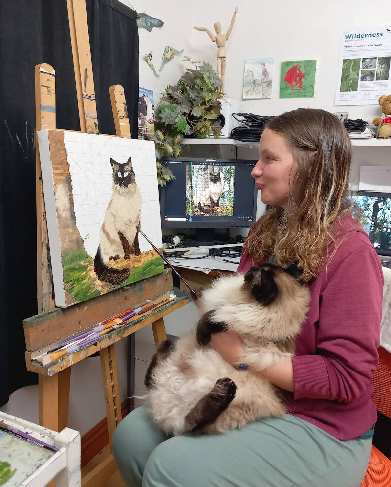 My wife Toni paints too, here she is painting a portrait of Merlin, with real Merlin checking out her progress. 
#cats #ragdoll