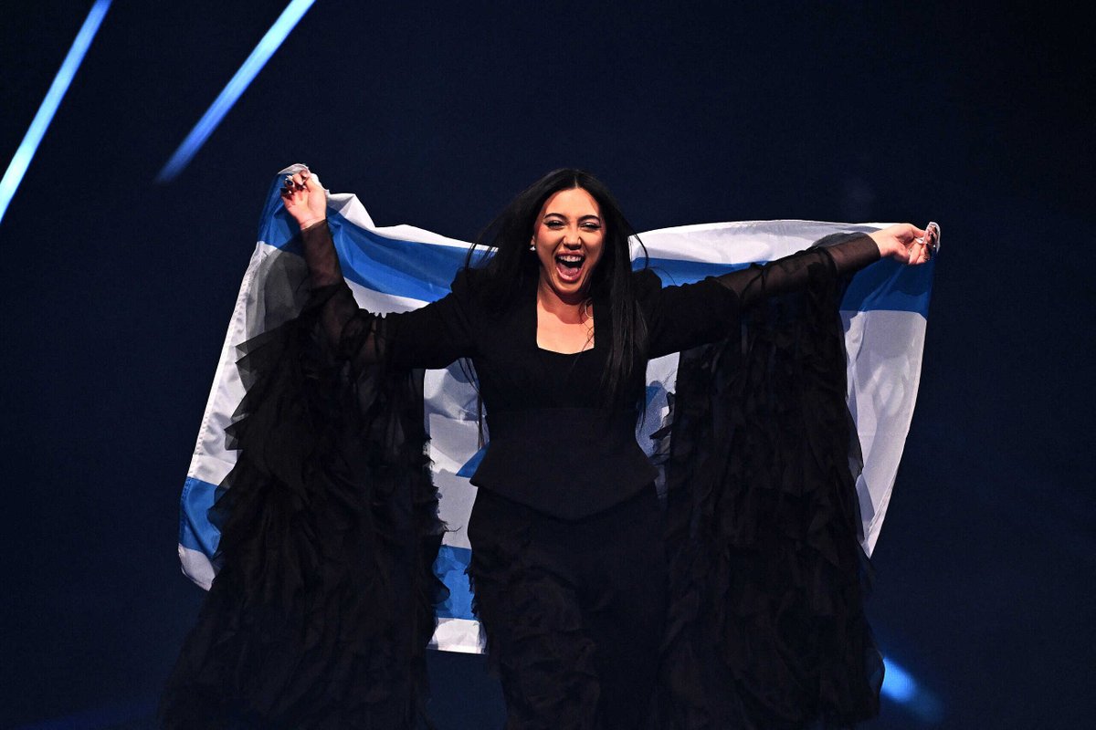 HenMazzig's tweet photo. Yuval Raphael survived the Nova massacre. 

She hid, terrified, in a bomb shelter, as Hamas murdered the people around her.

She shared her story across the world at the UN. 

She triumphed on Europe's biggest stage, taking 2nd place at Eurovision. 

Now, Eurovision is trying to silence Israeli artists like Yuval. 

Make no mistake: Europe isn't standing up for anyone's humanity. 
They just can't stand to see ours.