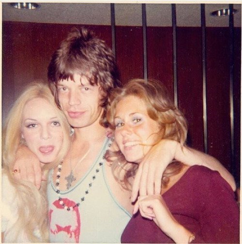crockpics's tweet photo. Mick Jagger, Playmate Mercy Rooney, and unidentified Playboy bunny at the original Playboy Mansion in Chicago, 1972. https://t.co/yaciv3kB7X