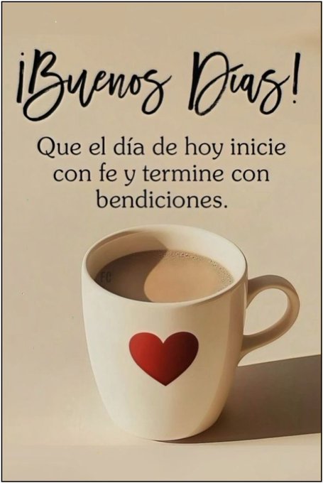 A white mug with a red heart design, filled with coffee. The mug sits on a light-colored surface with a soft shadow beneath it. Text above the mug reads "¡Buenos Días! Que el día de hoy inicie con fe y termine con bendiciones."