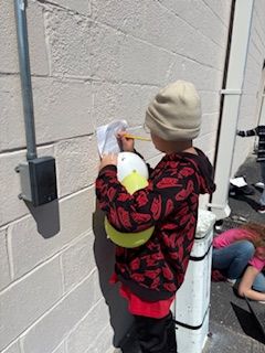 Students explored light wave energy transfer using a magnifying glass to pop balloons of different colors. They recorded how light is absorbed and reflected by surfaces. #ScienceExperiment #STEM #thatsNEAAAT