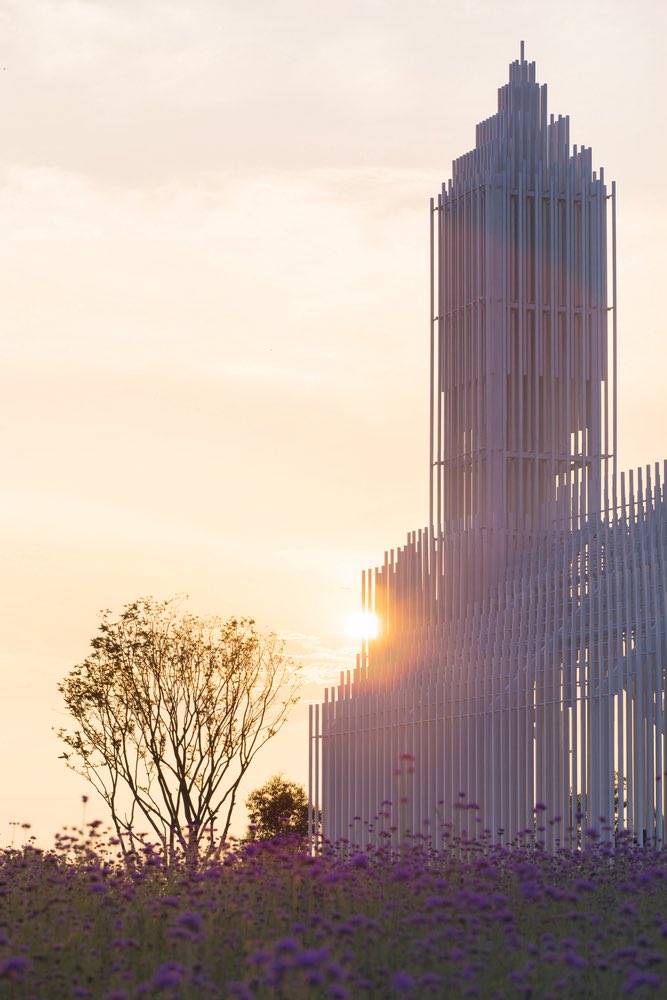 At sunset, the translucent façade diffuses natural light across its ...