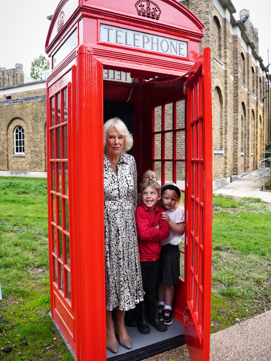 Queen Camilla joins eight pupils from Dulwich Village Infants' School inside the original telephone box during a visit to Dulwich Picture Gallery in south east London, to open the new Artplay Pavilion and Sculpture Garden