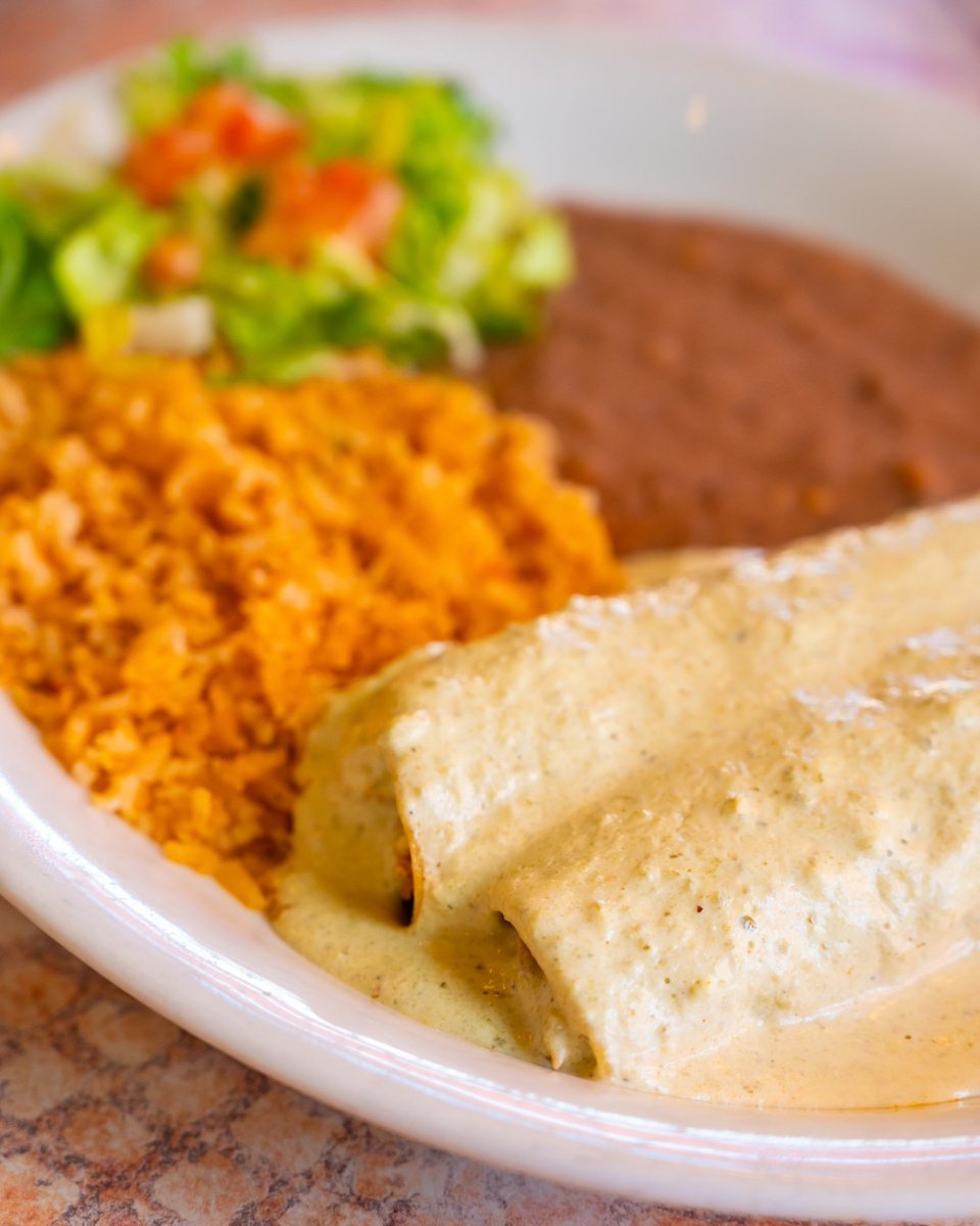 Thursday comfort on a plate, $9.99 chicken enchiladas topped with creamy poblano sauce, served with rice &amp; beans. 💚✨ 

Available all day, dine-in only.