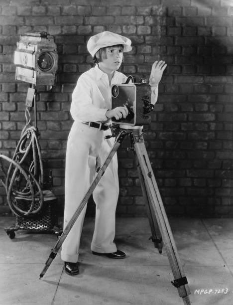 Jackie Coogan taking being on the other side of the camera extremely seriously, ca. 1930
