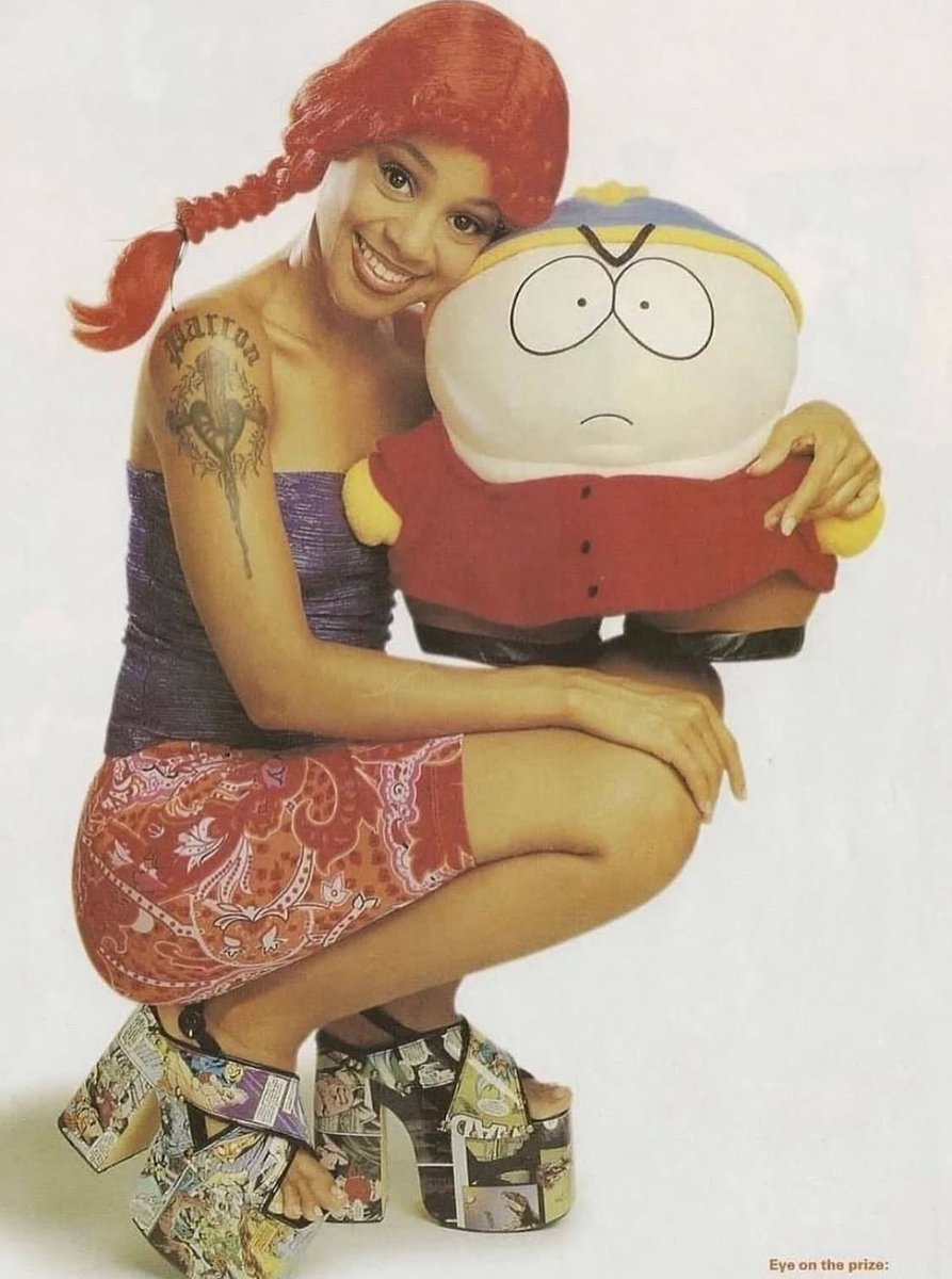Lisa 'Left Eye' Lopes poses with Eric Cartman, 1999