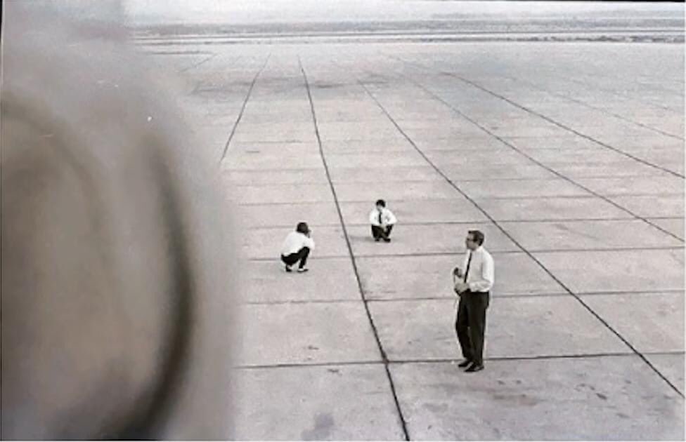 paul mccartney being photographed by george harrison on an airport runway - july 2, 1964 (allegedly).