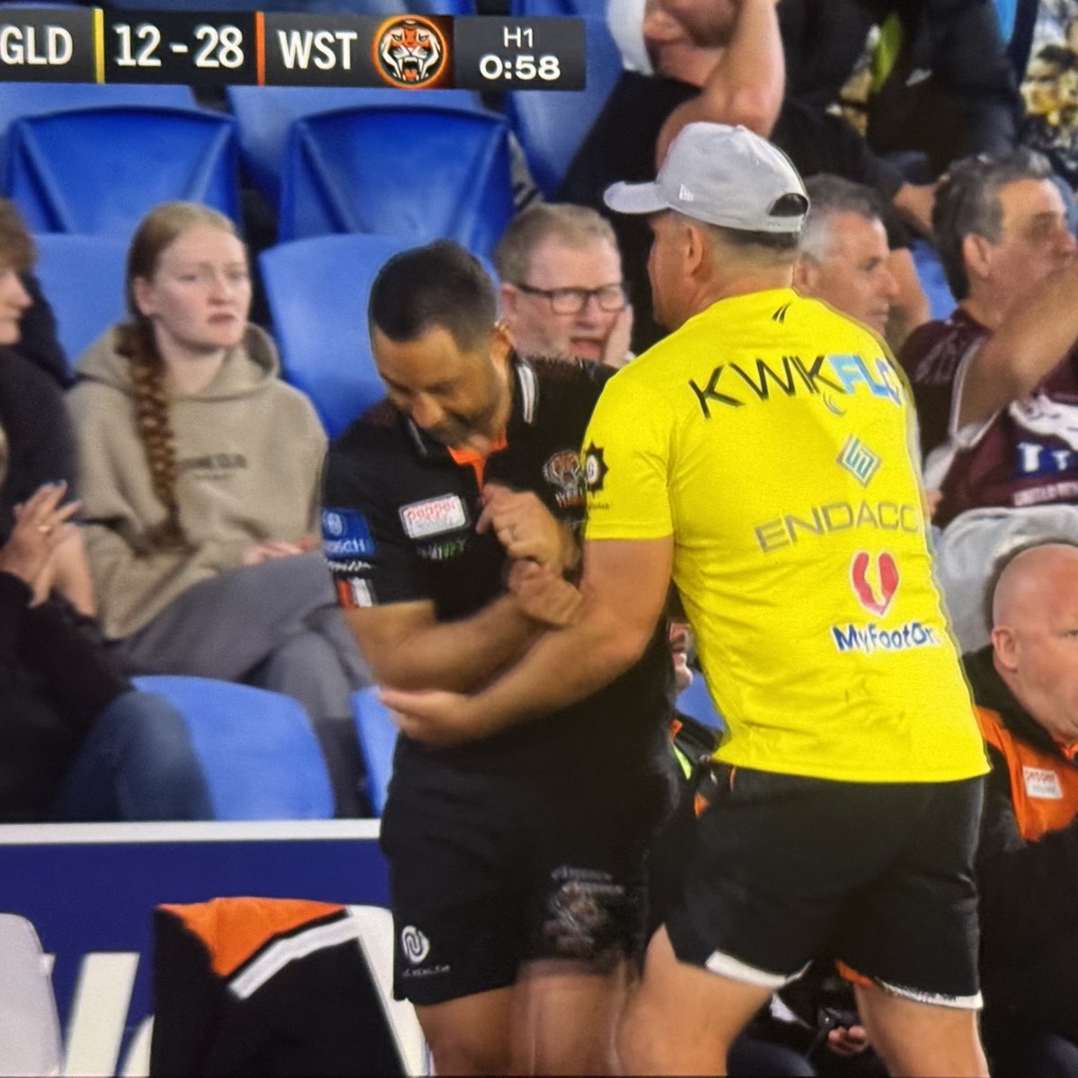 Pitch invader grabbed by a trainer