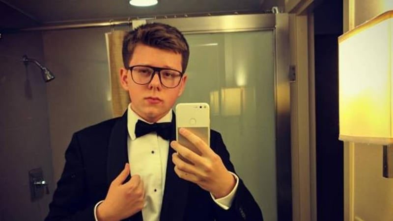 Young Erik Finman in a tuxedo taking a selfie