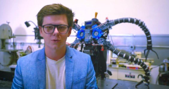 Erik Finman with a robotic suit in a lab