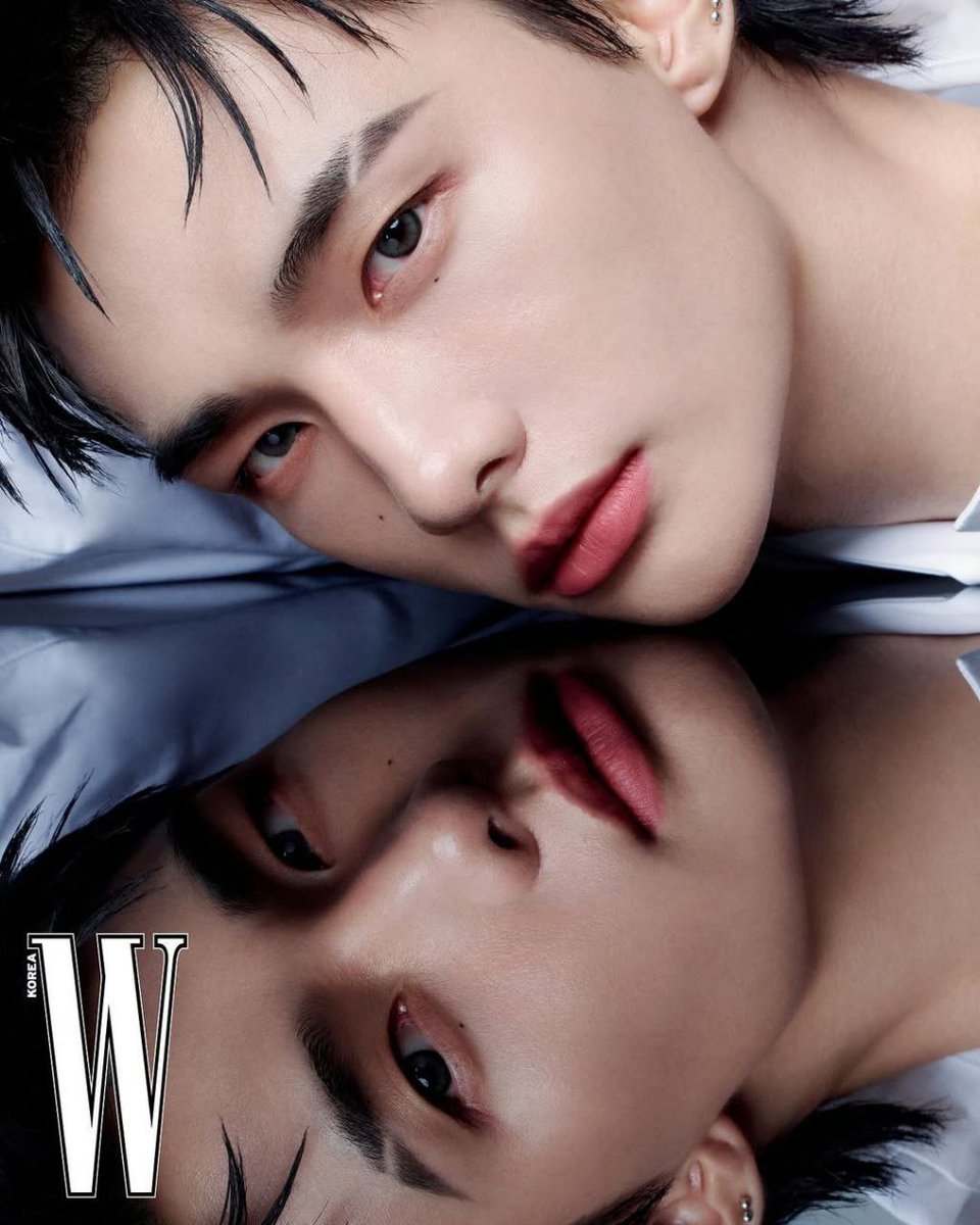 A face caught between dream and reflection, where reality bends into its own echo. The gaze is steady yet distant, as if searching for something hidden beneath the surface of the glass. Soft shadows trace the lines of beauty, blurring the border between self and mirror.